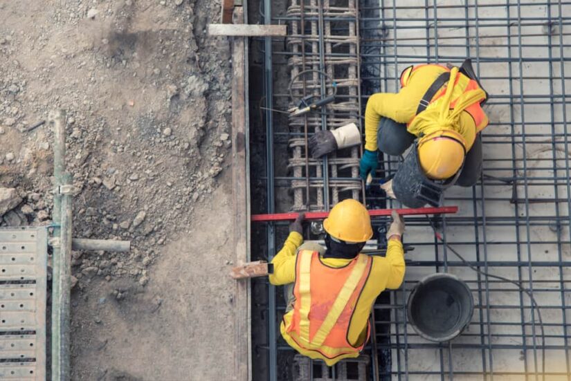 Two Construction Workers Welding Metal Construction